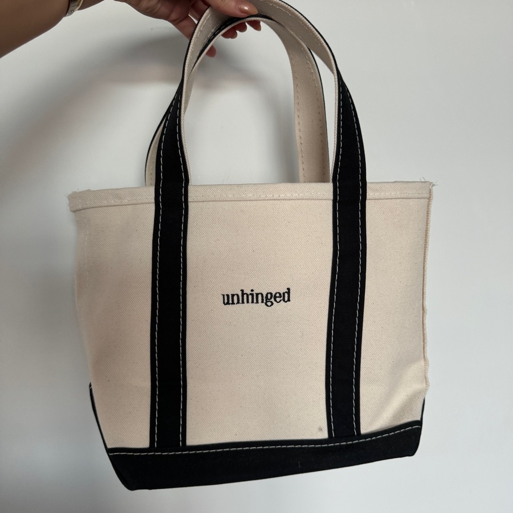 Custom black & white LL Bean boat and tote monogrammed with the word “unhinged”